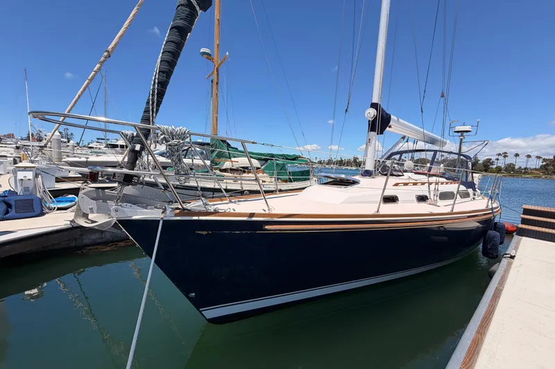 Slide: The Image of 2002 Sabre 362 sailboat docked at marina under clear blue sky. - 7
