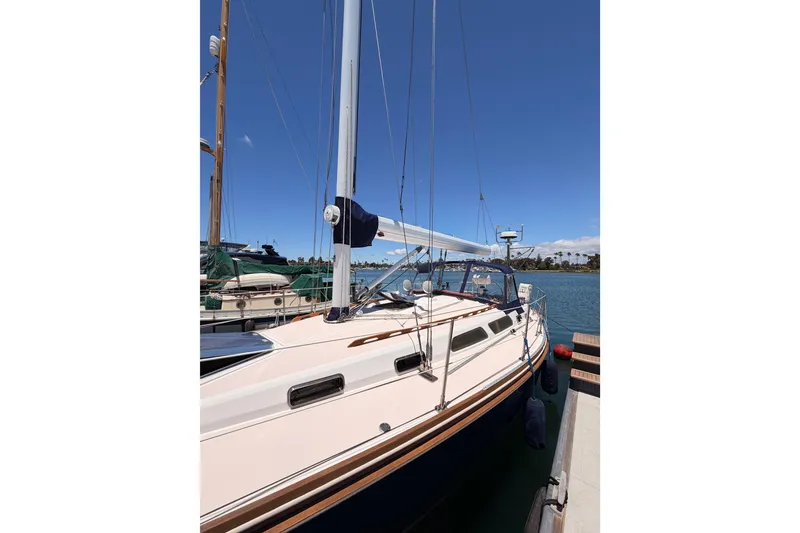 Slide: The Image of 2002 Sabre 362 sailboat docked in a sunny marina, clear blue sky. - 9