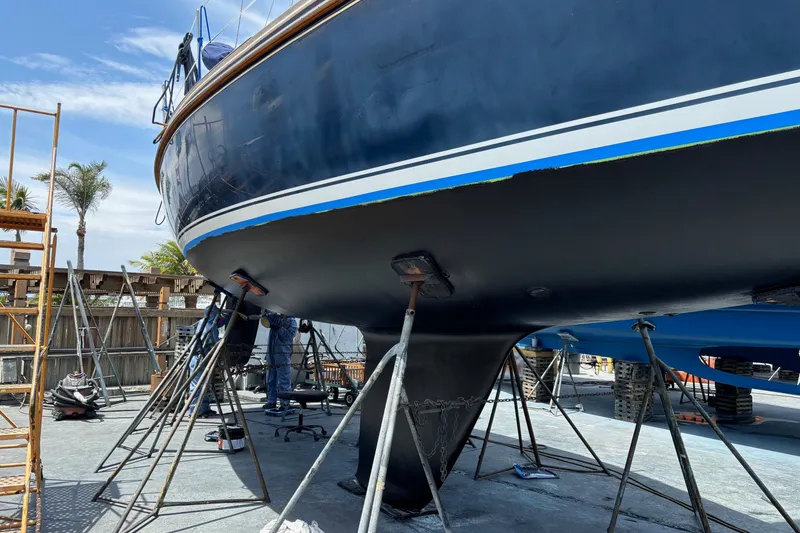 Slide: The Image of 2002 Sabre 362 sailboat on dry dock for maintenance, with visible hull and keel. - 94