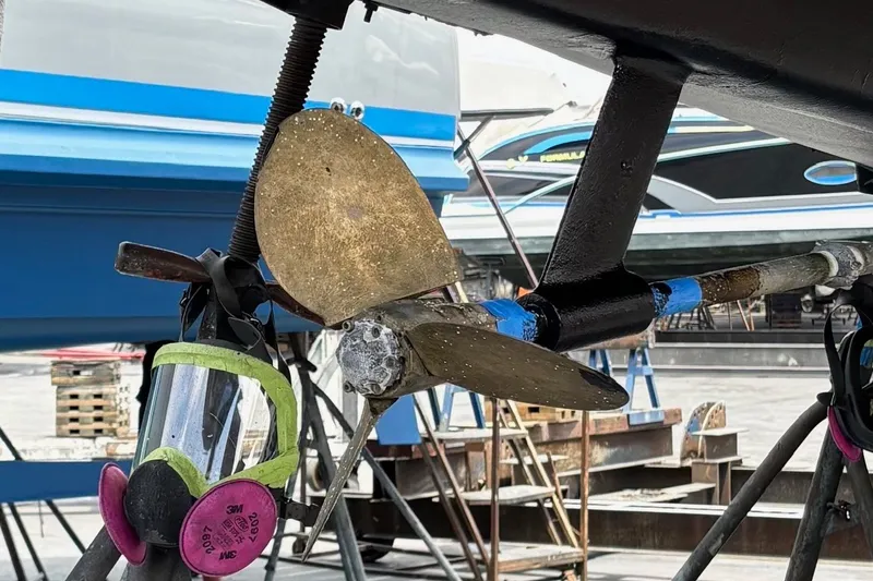Slide: The Image of Propeller of a 2002 Sabre 362 sailboat in a shipyard, with safety mask nearby. - 93