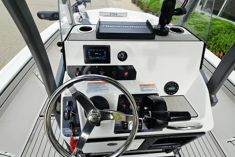 Slide: The Image of 2020 Yamaha Boats 195 FSH Sport dashboard with steering wheel and control panel. - 11