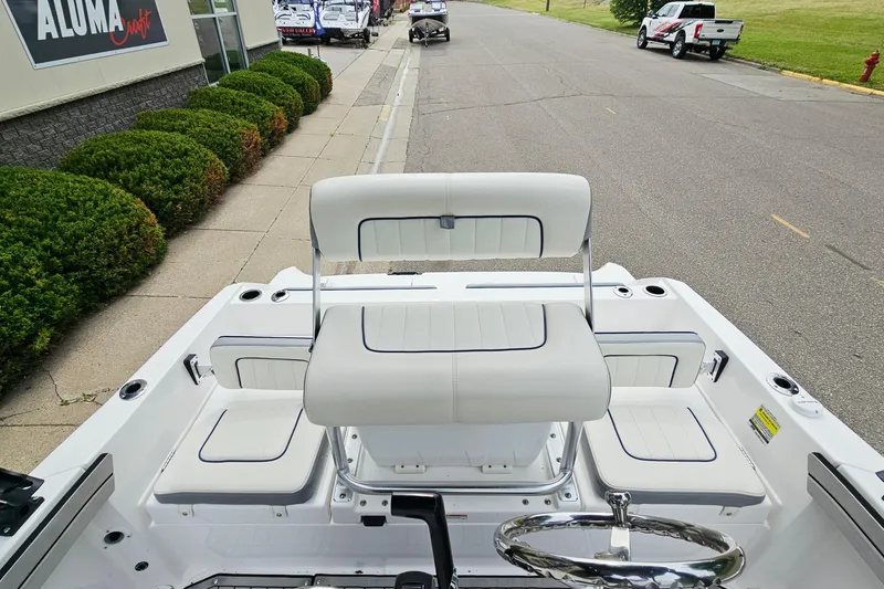 Slide: The Image of 2020 Yamaha Boats 195 FSH Sport interior with white seating and steering wheel. - 7