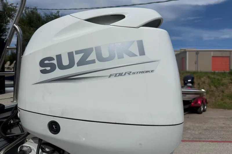 Slide: The Image of Suzuki Four Stroke engine on a 2023 Berkshire 20A CTS boat, outdoors. - 12