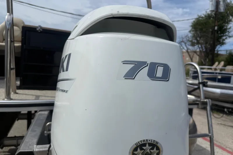 Slide: The Image of Outboard motor on a 2023 Berkshire 20A CTS pontoon boat, featuring a 70 horsepower engine. - 13