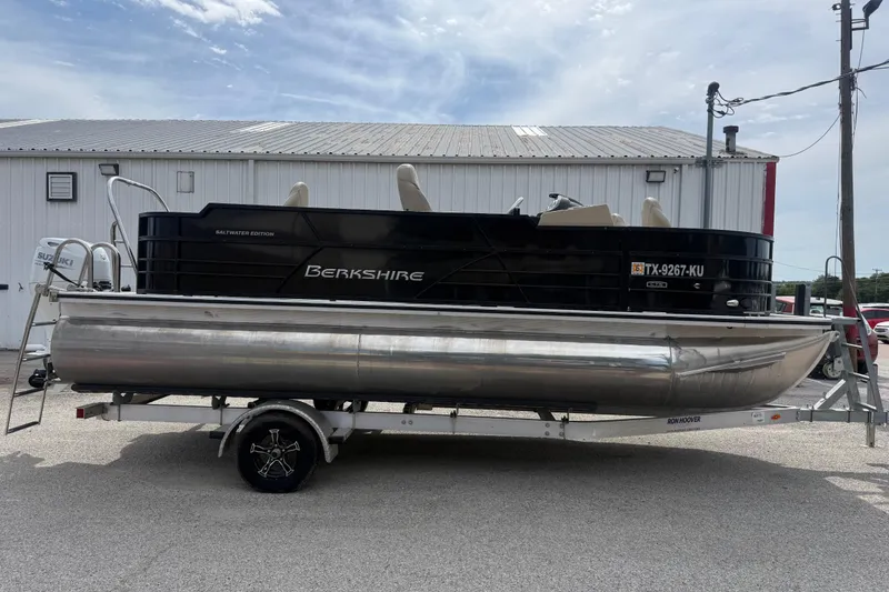 Slide: The Image of 2023 Berkshire 20A CTS pontoon boat on trailer, parked outdoors. - 16