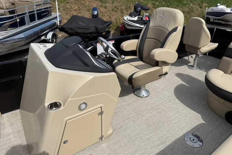 Slide: The Image of 2023 Berkshire 20A CTS boat interior with beige captain's chair and control console. - 23