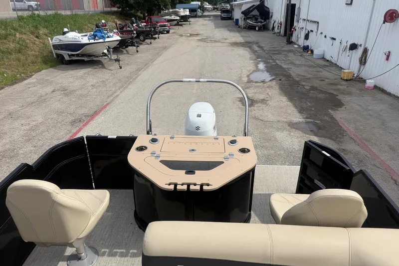Slide: The Image of 2023 Berkshire 20A CTS pontoon boat interior with beige seating and control panel. - 25