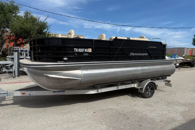 Slide: The Image of 2023 Berkshire 20A CTS pontoon boat on trailer, parked outdoors under clear sky. - 3