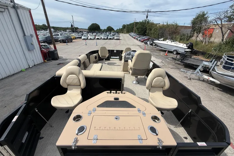 Slide: The Image of 2023 Berkshire 20A CTS pontoon boat with beige seating, parked outdoors. - 31
