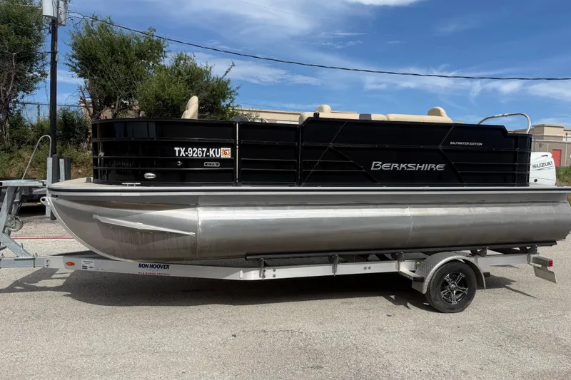Slide: The Image of 2023 Berkshire 20A CTS pontoon boat on trailer, parked outdoors under blue sky. - 4
