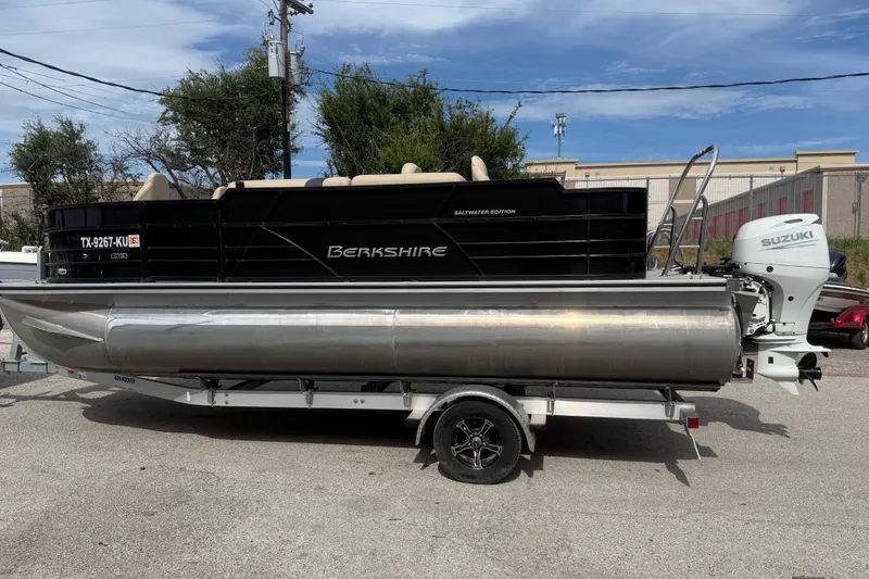 Slide: The Image of 2023 Berkshire 20A CTS pontoon boat with Suzuki outboard motor on trailer. - 6