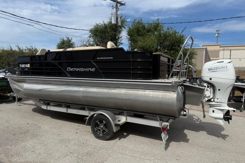 Slide: The Image of 2023 Berkshire 20A CTS pontoon boat with Suzuki outboard motor on trailer. - 7