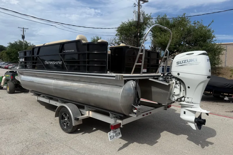 Slide: The Image of 2023 Berkshire 20A CTS pontoon boat with Suzuki outboard motor on trailer. - 8