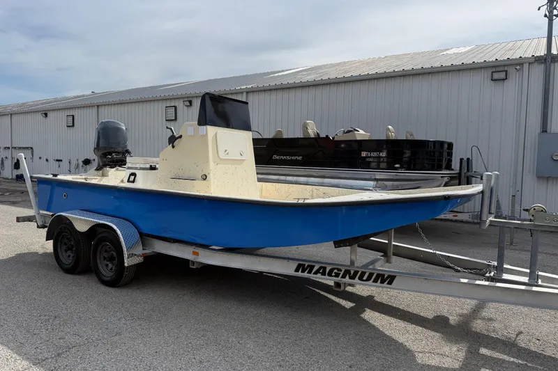Slide: The Image of 2007 Flats Cat 19 boat on a Magnum trailer, parked outside a warehouse. - 10
