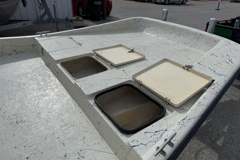 Slide: The Image of 2007 Flats Cat 19 boat deck with open storage compartments and speckled design. - 17