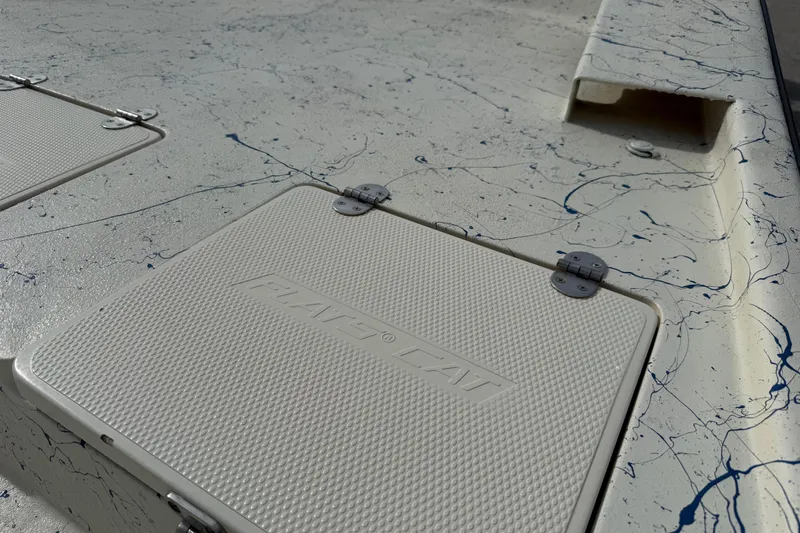 Slide: The Image of Close-up of a 2007 Flats Cat 19 boat deck with textured hatch covers. - 18
