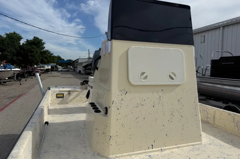Slide: The Image of 2007 Flats Cat 19 boat interior with console, parked in a marina under a blue sky. - 19