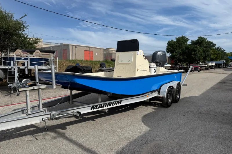Slide: The Image of 2007 Flats Cat 19 boat on trailer, blue hull, parked outdoors. - 2