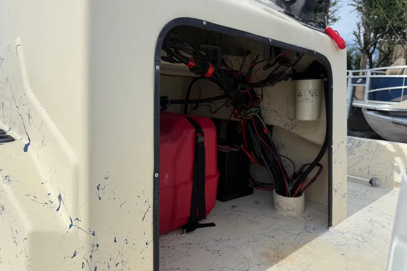 Slide: The Image of Interior view of a 2007 Flats Cat 19 boat showing wiring and storage compartment. - 26