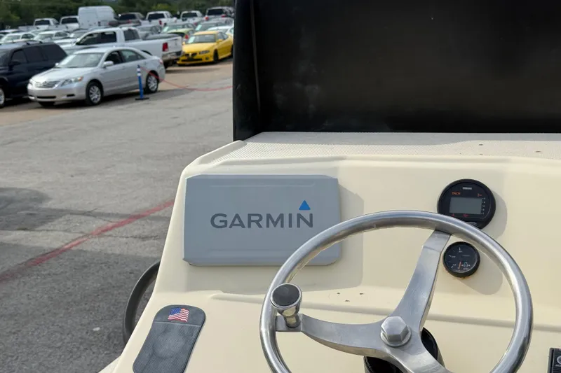 Slide: The Image of Steering wheel and Garmin device on 2007 Flats Cat 19 boat dashboard. - 28