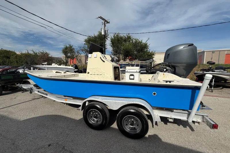 Slide: The Image of 2007 Flats Cat 19 boat on trailer, blue hull, outdoor setting. - 6