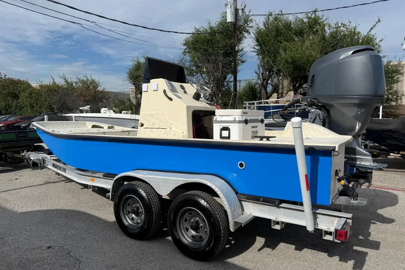 Slide: The Image of 2007 Flats Cat 19 boat on trailer, blue hull, outdoor setting. - 7
