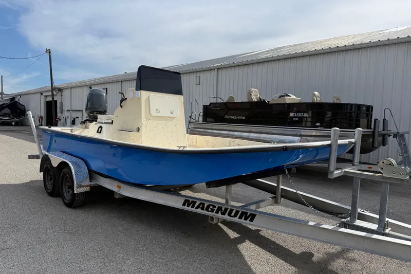 Slide: The Image of 2007 Flats Cat 19 boat on Magnum trailer, parked near a warehouse. - 9