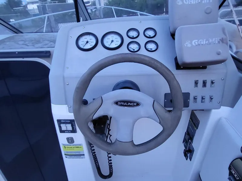 Slide: The Image of 2000 Bayliner 2252 Ciera Express helm with gauges and controls. - 13