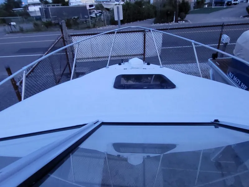 Slide: The Image of 2000 Bayliner 2252 Ciera Express boat, front view in marina. - 17