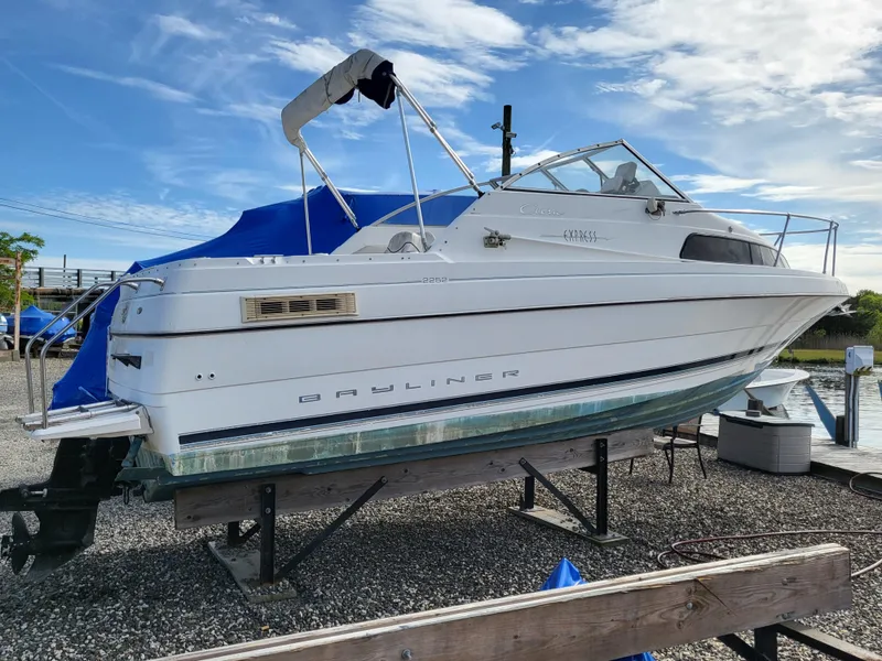 Slide: The Image of 2000 Bayliner 2252 Ciera Express on a boat stand at the harbor. - 19