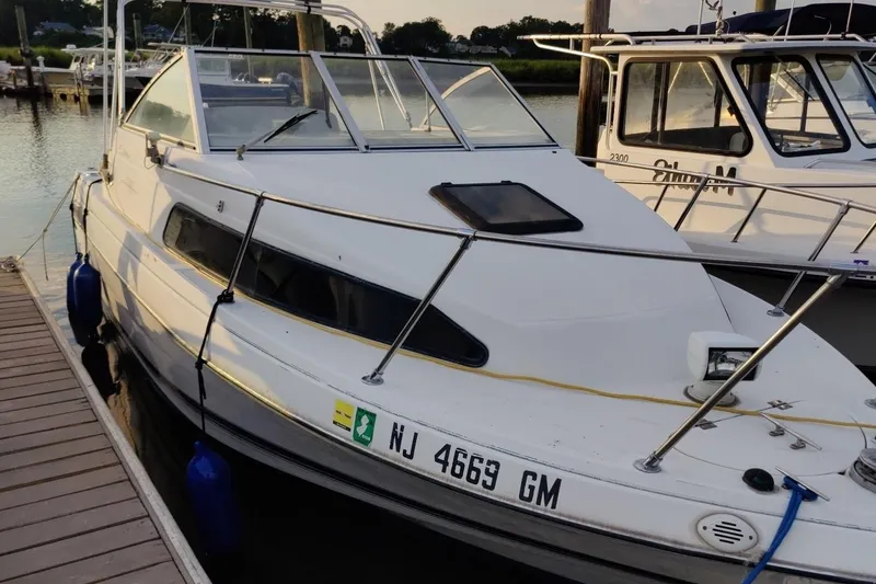 Slide: The Image of 2000 Bayliner 2252 Ciera Express docked at marina, side view. - 25