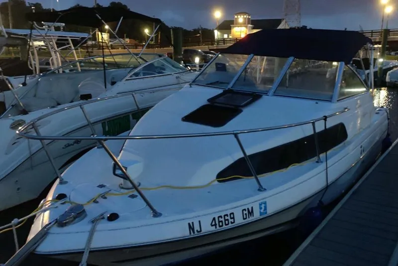 Slide: The Image of 2000 Bayliner 2252 Ciera Express docked at night, illuminated by marina lights. - 26