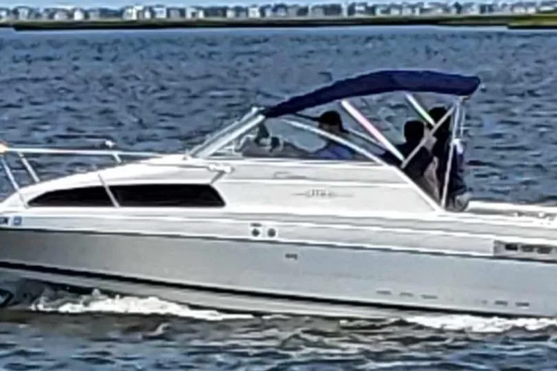 Slide: The Image of 2000 Bayliner 2252 Ciera Express cruising on open water with passengers. - 28