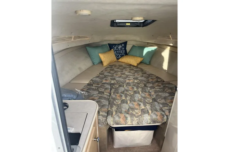 Slide: The Image of Cozy cabin interior of 2000 Bayliner 2252 Ciera Express with cushions and bedding. - 6