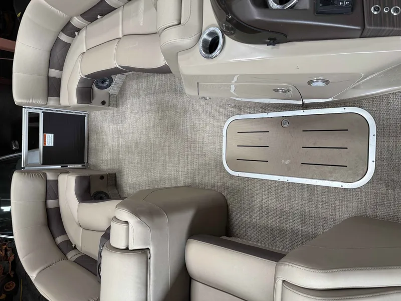 Slide: The Image of Interior of a 2020 Bennington RSB pontoon boat with beige seating. - 10
