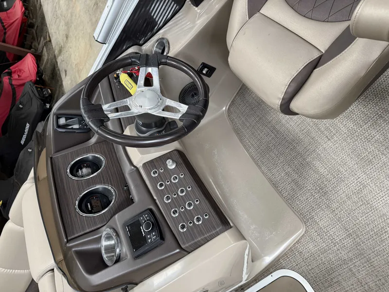 Slide: The Image of Interior of a 2020 Bennington RSB boat with steering wheel and control console. - 11