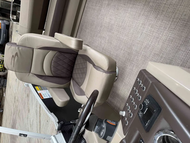 Slide: The Image of Interior of a 2020 Bennington RSB boat with luxurious seating and control panel. - 13