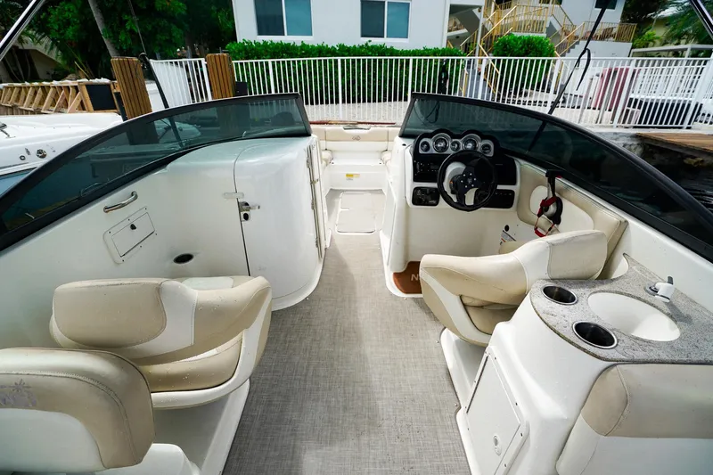Slide: The Image of 2017 NauticStar 243DC Sport Deck interior with helm, seating, and cup holders. - 11