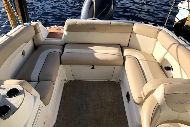 Slide: The Image of 2017 NauticStar 243DC Sport Deck boat interior with beige seating and cup holders. - 3