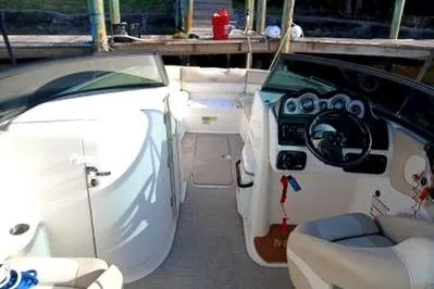 Slide: The Image of 2017 NauticStar 243DC Sport Deck boat interior with steering wheel and seating. - 5