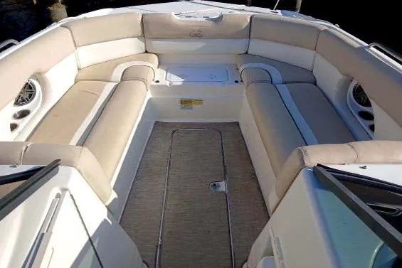 Slide: The Image of 2017 NauticStar 243DC Sport Deck boat interior with beige seating and spacious layout. - 6