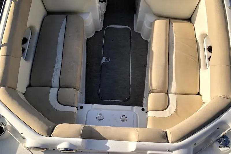 Slide: The Image of 2017 NauticStar 243DC Sport Deck boat interior with beige seating and carpeted floor. - 8