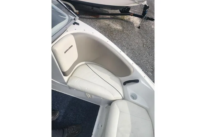 Slide: The Image of 2012 Sea-Doo Sport Boats 180 Challenger interior seating with white upholstery and cup holder. - 10
