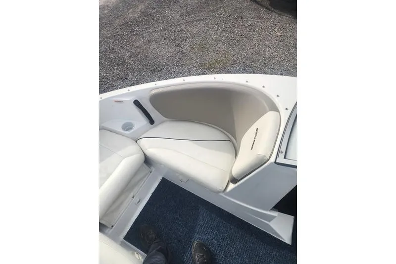 Slide: The Image of 2012 Sea-Doo 180 Challenger boat interior with white seating and blue carpet. - 11