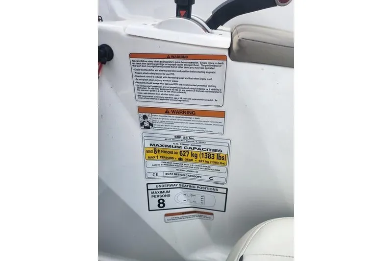 Slide: The Image of 2012 Sea-Doo 180 Challenger warning labels and capacity information, maximum 8 persons, 627 kg. - 12