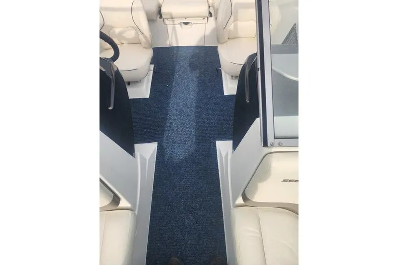 Slide: The Image of 2012 Sea-Doo 180 Challenger interior with blue carpet and white seating. - 13