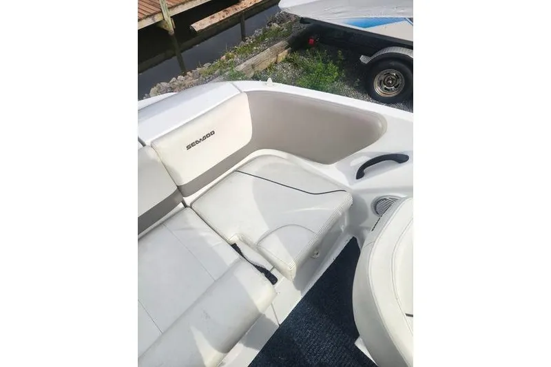 Slide: The Image of 2012 Sea-Doo Sport Boats 180 Challenger interior seating with white upholstery. - 16
