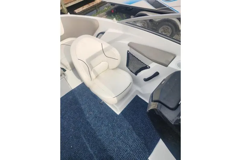 Slide: The Image of 2012 Sea-Doo 180 Challenger boat interior with white seating and blue carpet. - 19