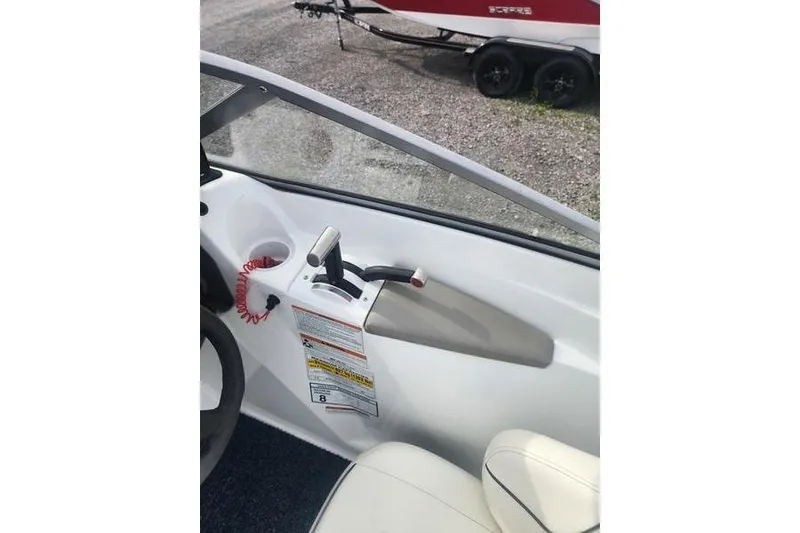 Slide: The Image of Interior view of a 2012 Sea-Doo Sport Boats 180 Challenger, showcasing throttle controls and seating. - 20