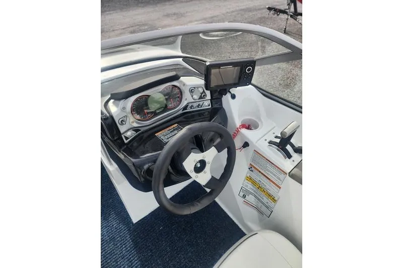 Slide: The Image of 2012 Sea-Doo 180 Challenger dashboard with steering wheel and control panel. - 21
